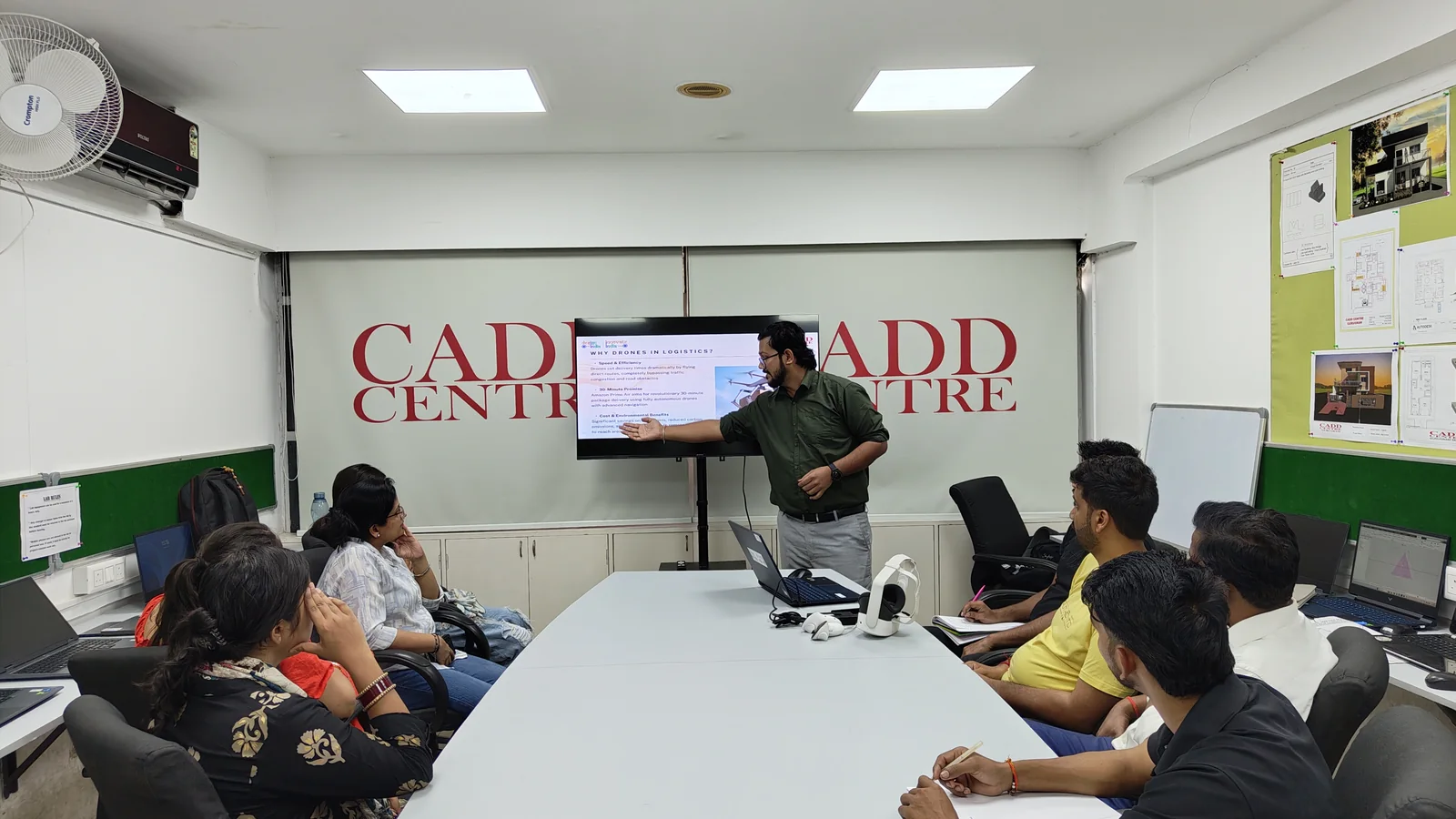 Learners around the table at CADD Centre Gurugram, Sector 14, working through a career session shown on screen