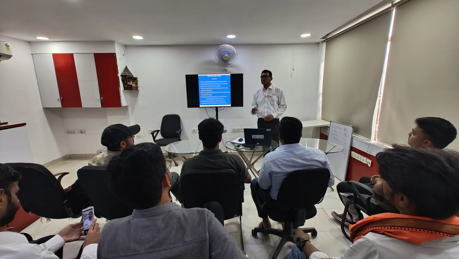A trainer taking a session at CADD Centre Gurugram, Sector 14, with the class seated in front of the screen