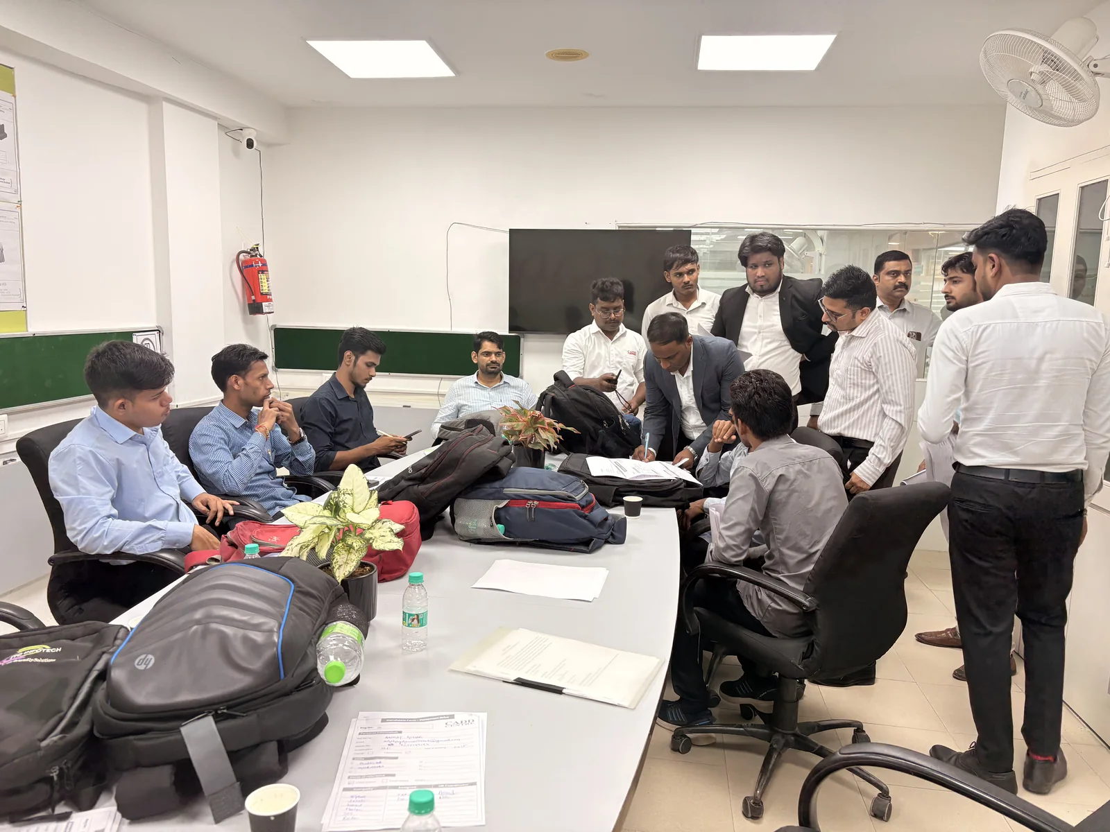 Candidates seated around tables with their CVs during a recruitment drive at CADD Centre Gurugram, Sector 14